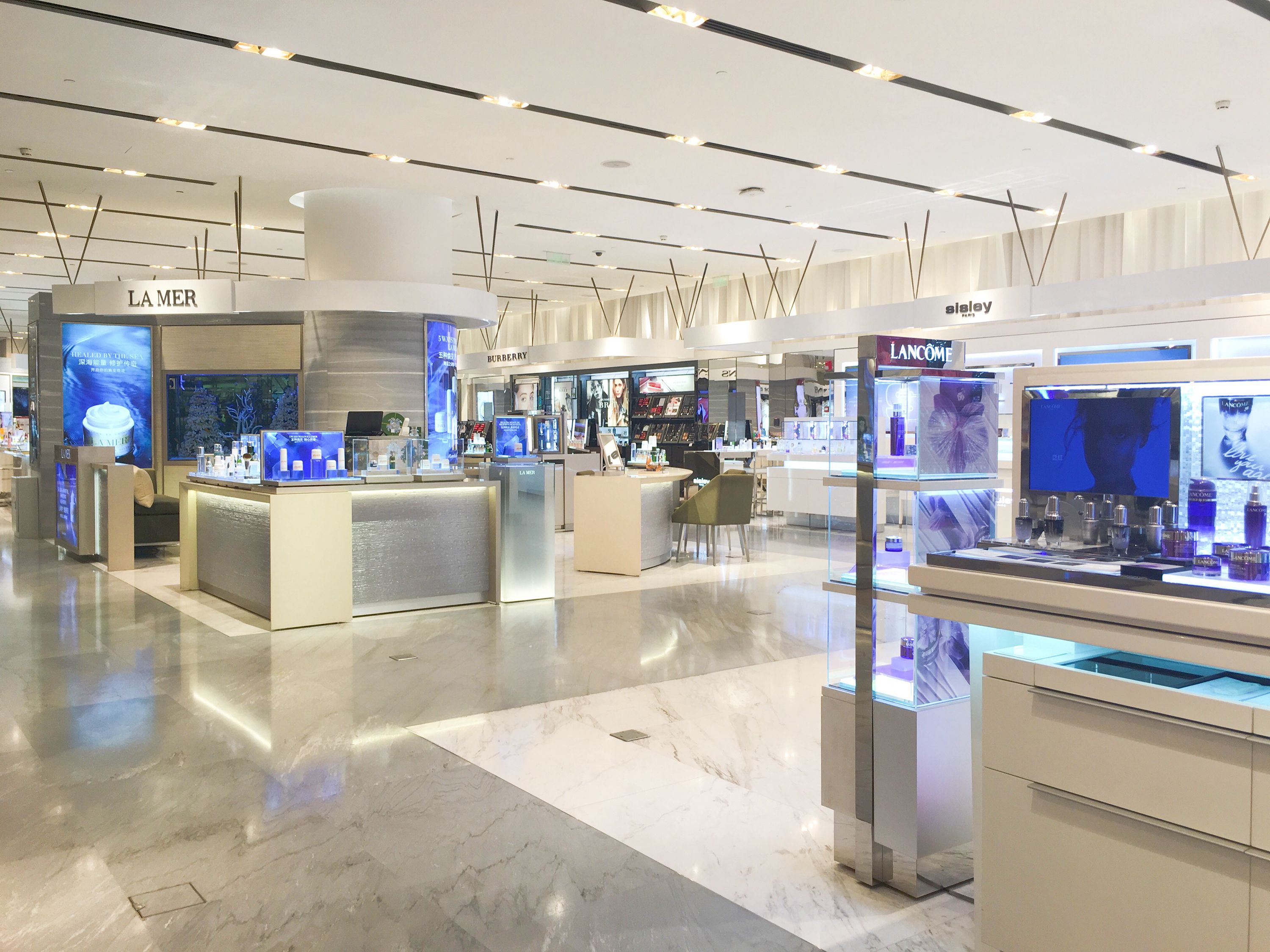 布局上，该区摈弃了将各品牌专柜呈块状整齐罗列的方式，而是以一条动线为轴，将各品牌专柜分布于动线两侧。整体装修色系以白色为主，各品牌LOGO以白底黑字呈现，显得简约、大气。