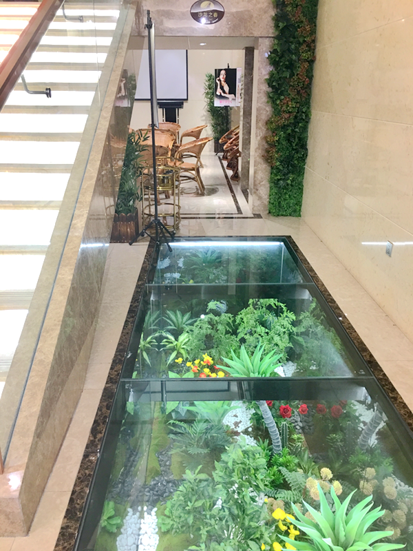 楼梯一角的空间，被利用起来当作一个小型的培训室或休息区，为了更加美观，该区域还增设了地面玻璃植物景观。