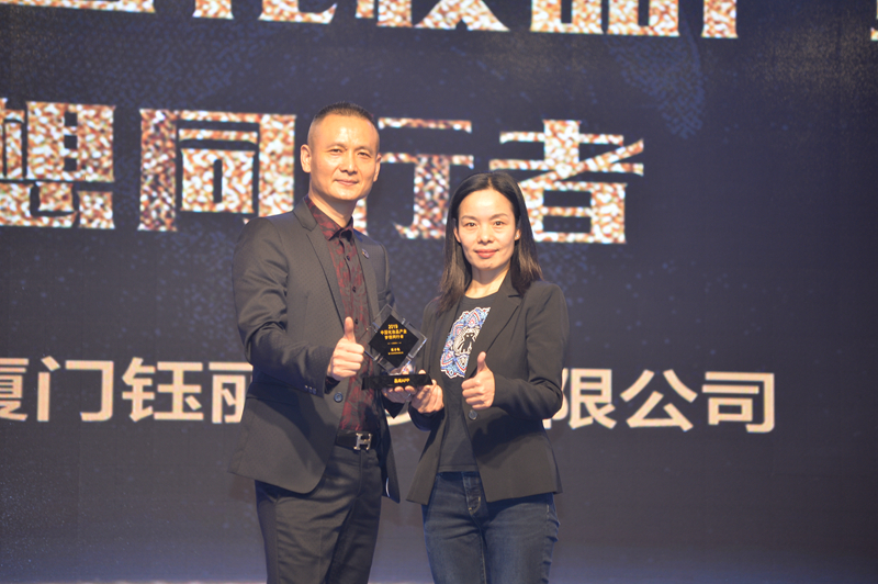 1551752896341553.jpg 品观APP董事长邓敏为钰丽商贸总经理陈子稳颁发“2019中国化妆品产业梦想同行者”奖杯_副本.jpg